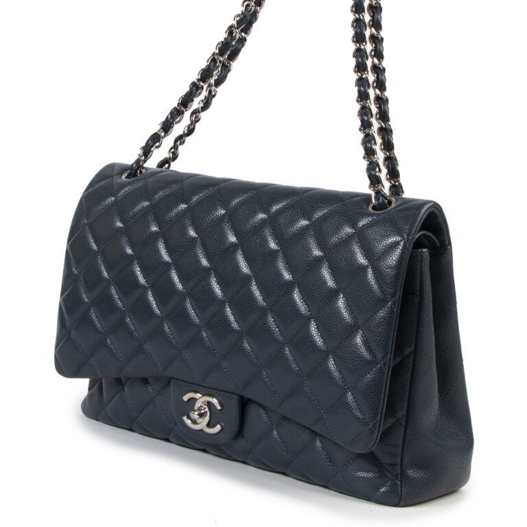 At Auction: A CHANEL BLACK QUILTED CAVIAR LEATHER MAXI CLASSIC DOUBLE FLAP  BAG. 22CM X 34CM. GOLD TONE HARDWARE, EXTERIOR OPEN POCKET, 4X INTERIOR  POCKETS. PLEASE SEE PHOTOS FOR CONDITION. COMES WITH