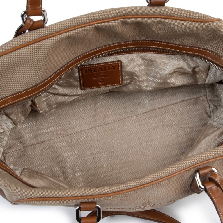 Prada Bauletto hand bag. Used handbag. Color brown and red. Offers