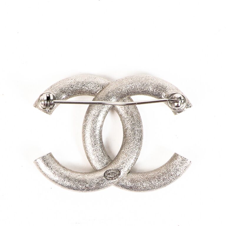 Silver on sale chanel brooch