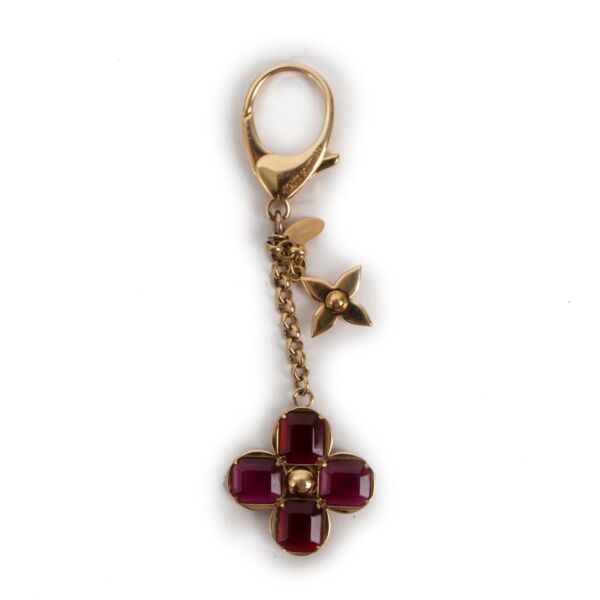 Buy an authentic vintage Louis Vuitton Gold Burgundy Brass Monogram Flower Key Chain at Labellov Antwerp in good condition.
