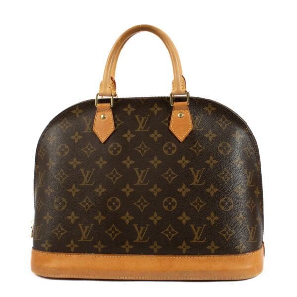 Classic elegance meets everyday functionality with this Louis Vuitton Monogram Alma MM Top Handle Bag. Featuring the iconic LV monogram canvas, this timeless design is accented by smooth leather trim and gleaming gold-tone hardware. Its structured silhoue