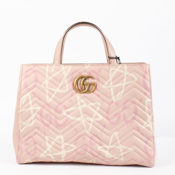 Shop the authentic Gucci GG Marmont Graffiti Matelassé Tote in pink leather at Labellov.com.