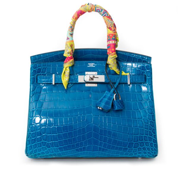 Add a touch of Mediterranean flair to your wardrobe with this Hermès Birkin bag in Blue Izmir Crocodile Niloticus. Exotic, cheerful and yet sophisticated with silver-tone paladium hardware emphasizing the cool blue shade.   The bag was only recently boug