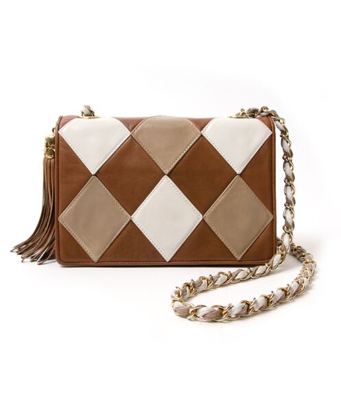 Adorable Chanel bag in cognac and cream lambskin, with leather tasse. Gold hardware throughout. Signature chain shoulder strap.  Authenticity card N° 1297332
