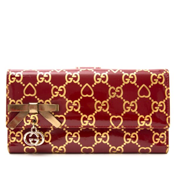 Buy an authentic Gucci Red Monogram Heart Wallet online