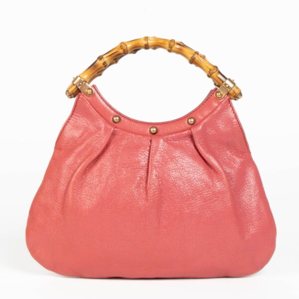 Shop this 100% authentic Gucci Pink Pebbled Leather Bamboo Handle Hobo Bag at labellov.com.