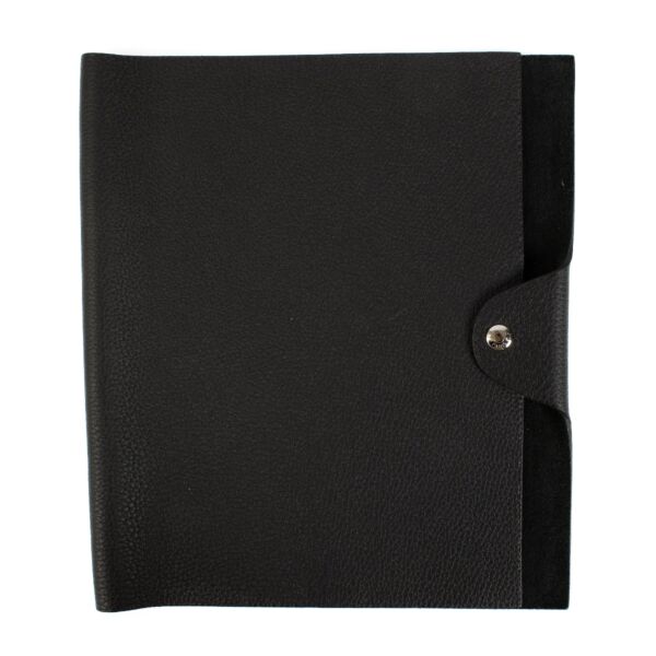 The Hermès Ulysse is a sleek leather notebook holder with a minimalist design, featuring luxurious craftsmanship and a spacious interior for essentials.