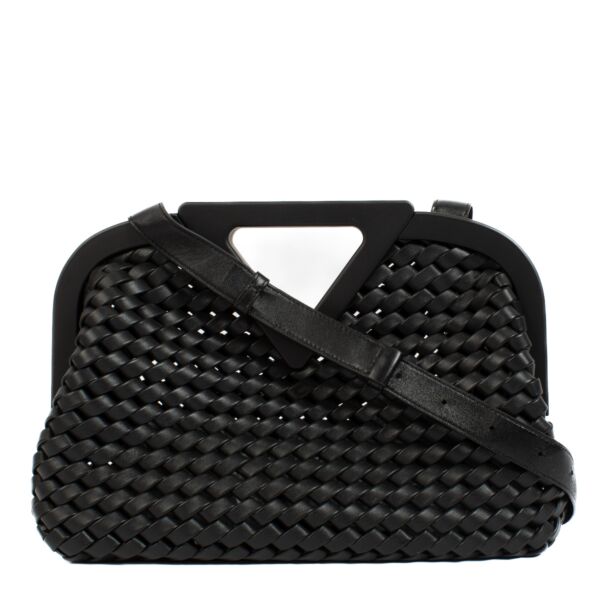 A modern classic, the Bottega Veneta Point Bag in black woven leather reimagines the brand's signature craftsmanship with contemporary flair. Featuring Bottega Veneta's iconic intrecciato weave, this bag showcases the artistry and precision synonymous wit