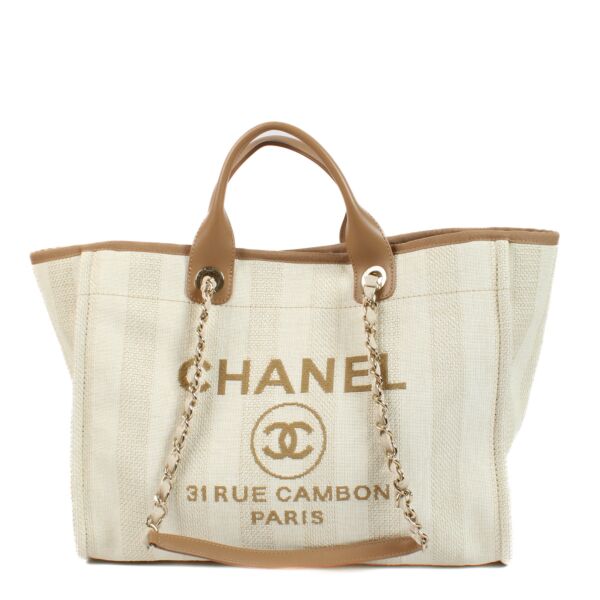 Chanel Beige Striped Canvas Deauville Shopper Bag for the best price at Labellov secondhand luxury in Antwerp and Knokke. Buy and sell your preloved and brand new designer bags.