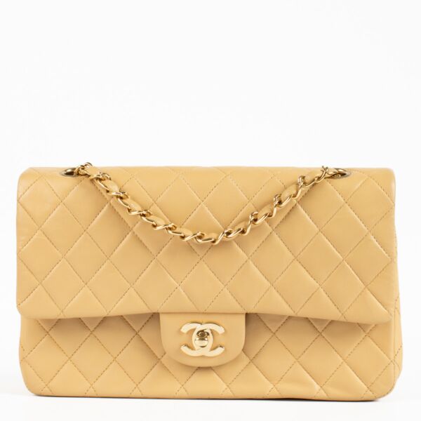 An exquisite example of timeless Chanel elegance, this Chanel Vintage Classic Flap Bag is crafted in beige quilted lambskin leather, offering a refined alternative to the traditional black. T