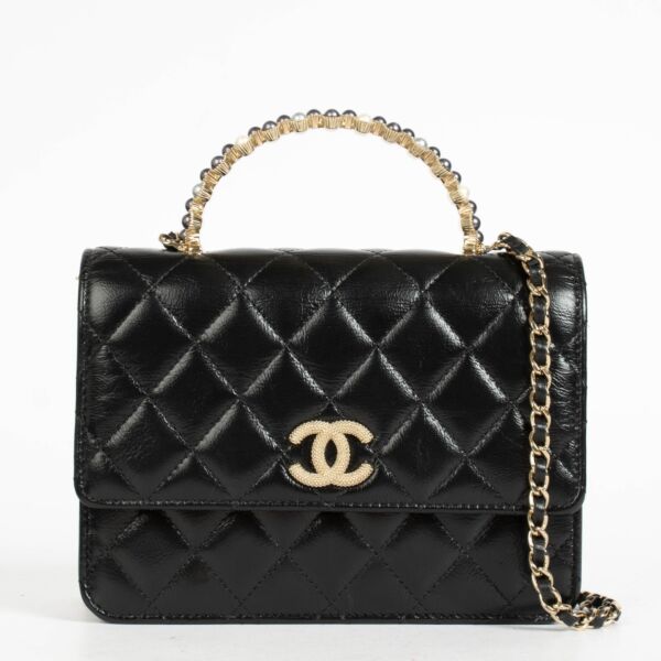 Authentic pre-loved Chanel Black Lambskin Pearl Top Handle Clutch With Chain on Labellov.com