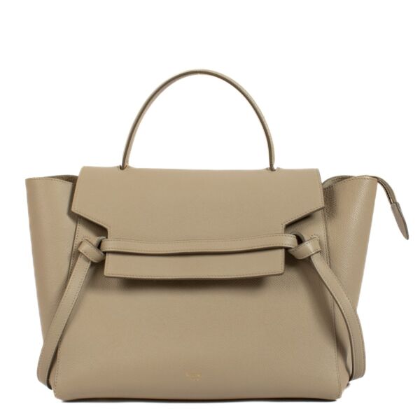 The Celine Beige Mini Belt Bag is a chic and compact leather accessory featuring a structured design, belt buckle closure, and detachable shoulder strap, perfect for day-to-night wear. Shop now on Labellov.com.