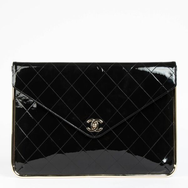 Shop this authentic Chanel Black Patent Leather Metal Frame Clutch pre-loved on Labellov.com 