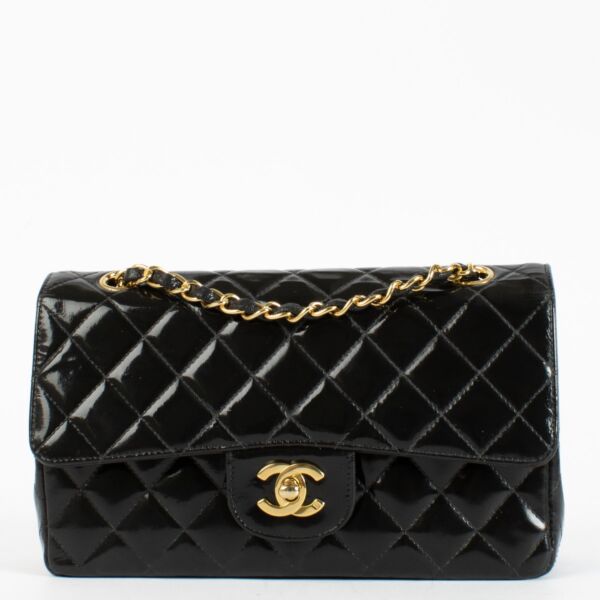 Shop the Chanel Classic Double Flap Bag in black patent leather with gold hardware at Labellov.com
