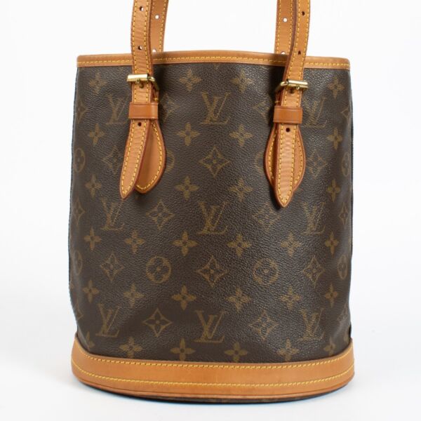 Authentic Louis Vuitton Petit Bucket bag in Monogram canvas with vachetta leather trim at Labellov.com