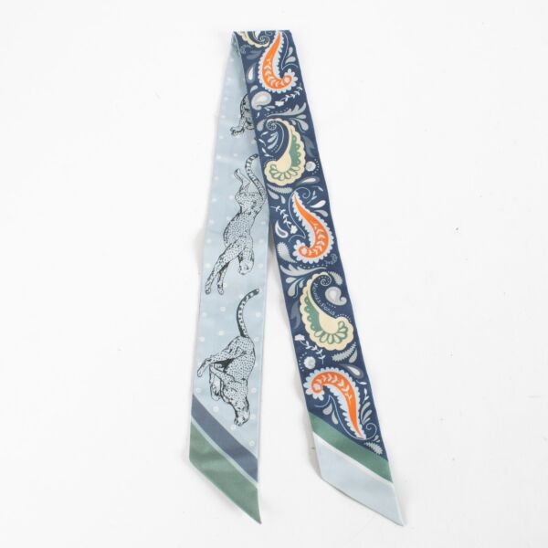 Are you looking for an authentic designer accessory? We buy and sell your preloved and brand new Hermès Blue Guepards Bandana Silk Twilly.