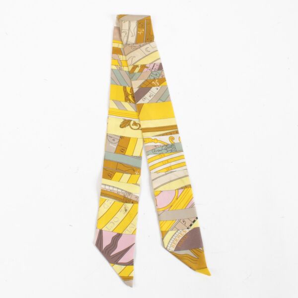 Are you looking for an authentic designer accessory? We buy and sell your preloved and brand new Hermès Yellow Astrologie Nouvelle Twilly Scarf.