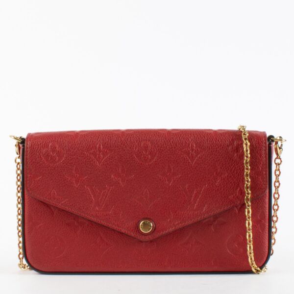 Red Louis Vuitton Monogram Empreinte Pochette Félicie wallet-on-chain with gold chain strap.