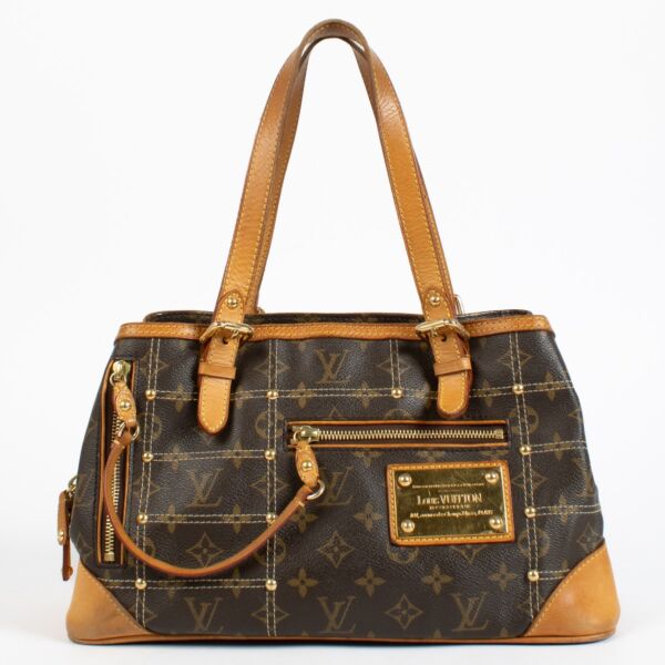 Louis Vuitton Monogram Rivets Handbag with gold rivet detailing and natural leather handles at Labellov.com