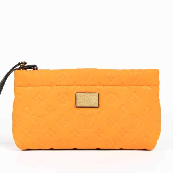 Shop this 100% authentic Louis Vuitton Orange Neoprene Scuba Clutch at Labellov.com