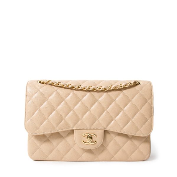 Votre Luxe - Chanel Nude Jumbo Classic Flap Bag ($8550)​​​​​​​​ ​​​​​​​​  This elegant Chanel jumbo bag is in nude caviar leather with gold-tone  metal hardware. In excellent 